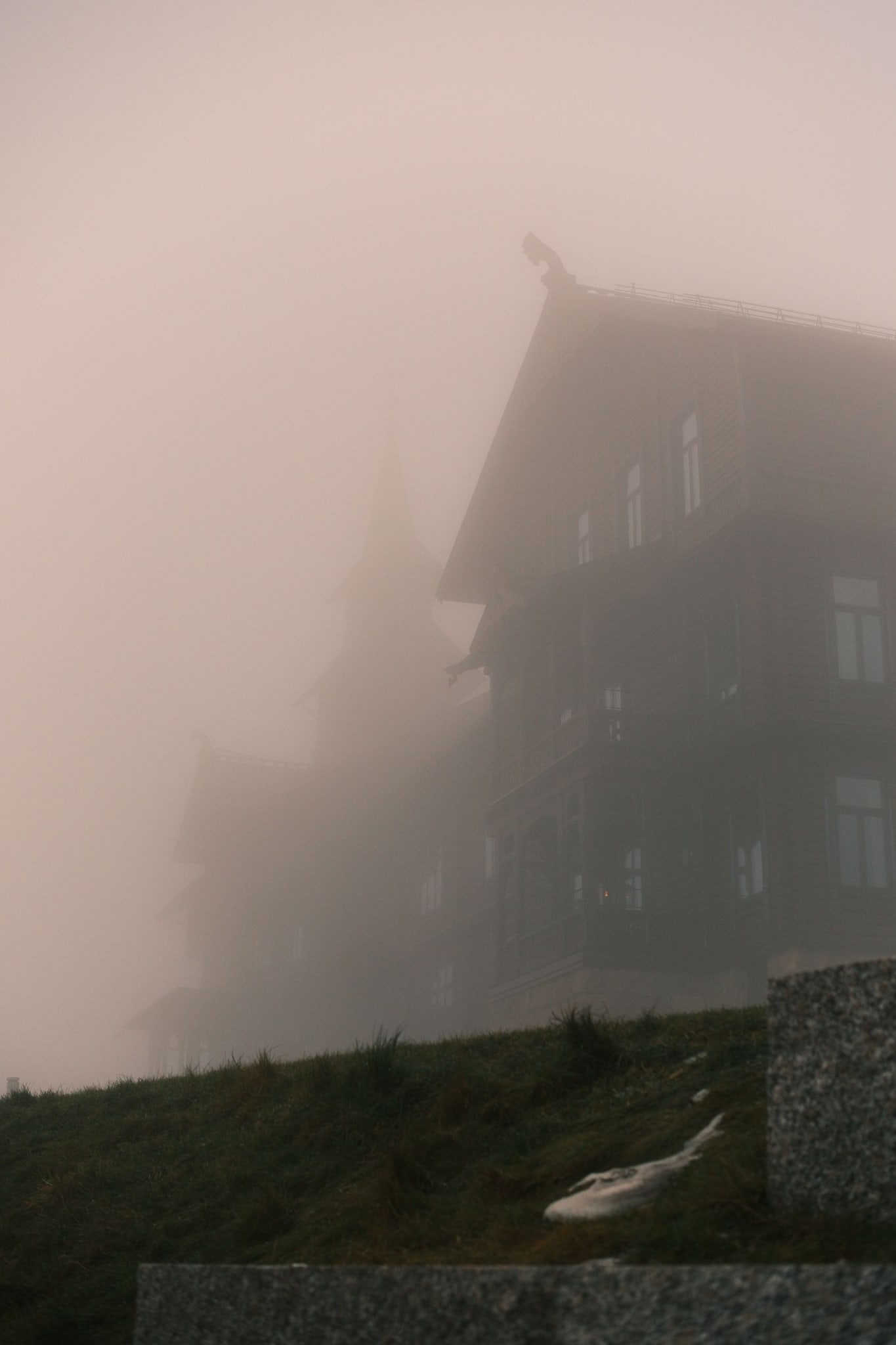 Misty wooden house at night