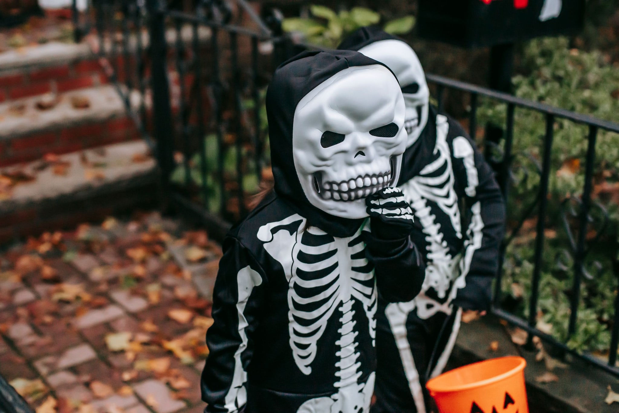 Kids in black skeleton costumes