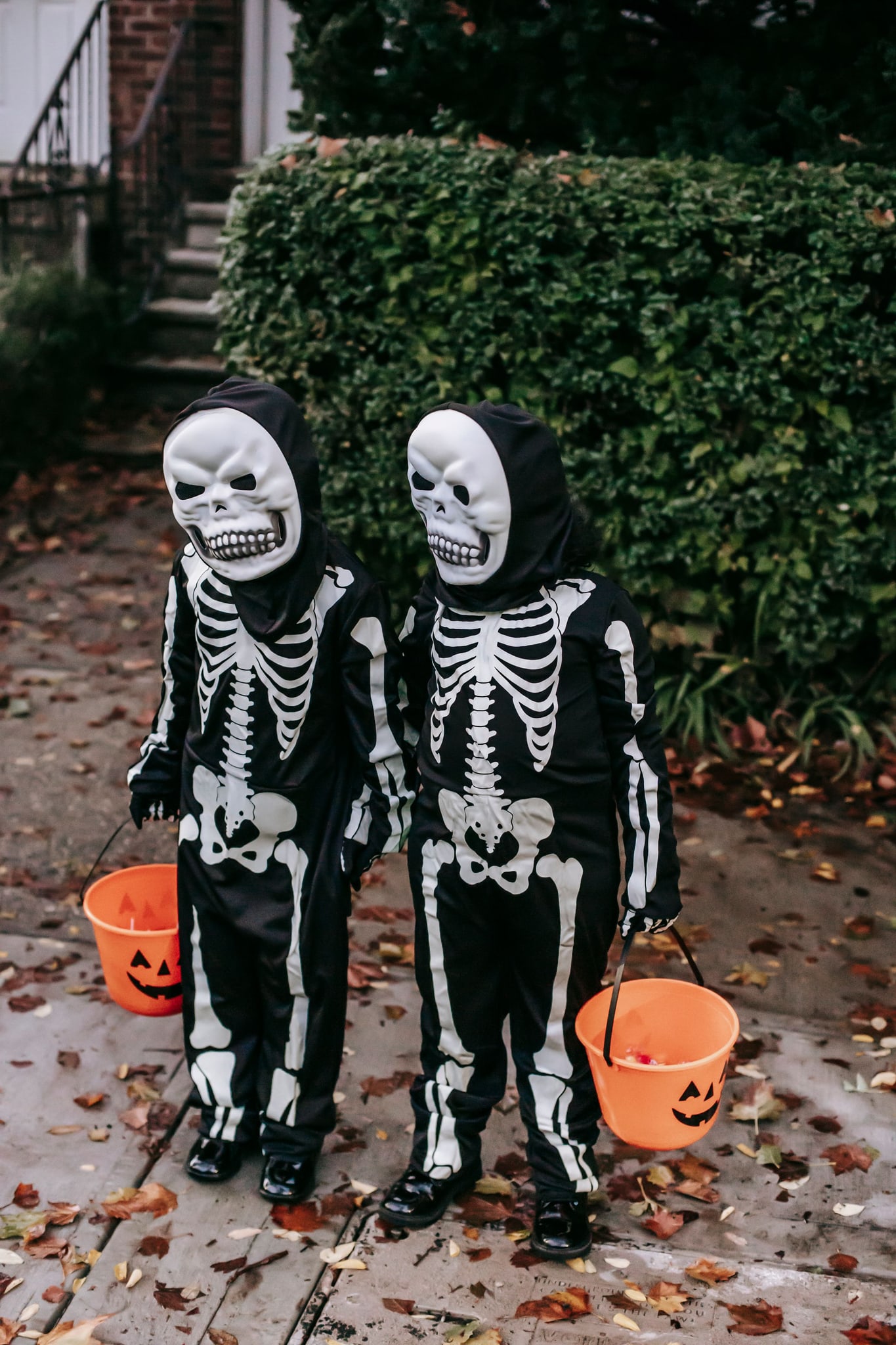 Kids in skeleton costumes with buckets