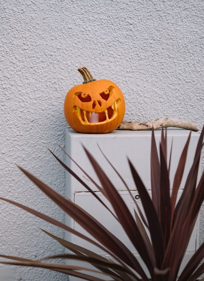 Spooky carved pumpkin outdoors