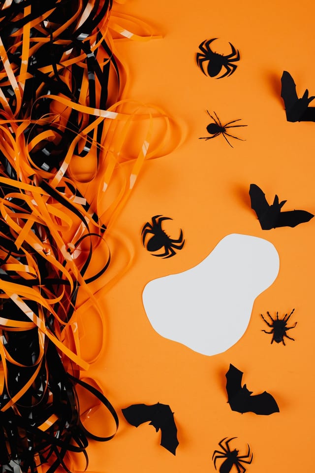 Paper bats and spiders on orange
