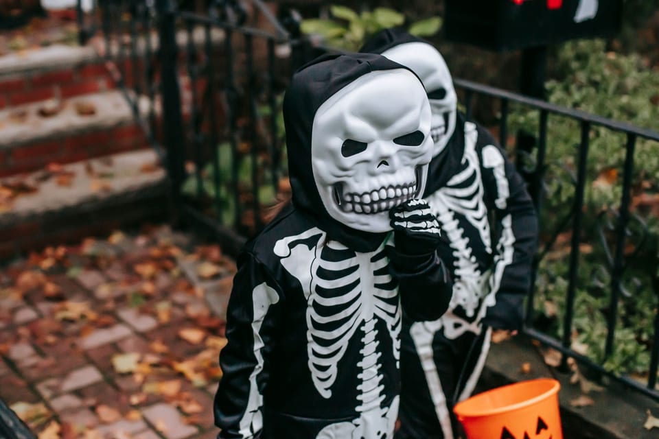 Kids in black skeleton costumes