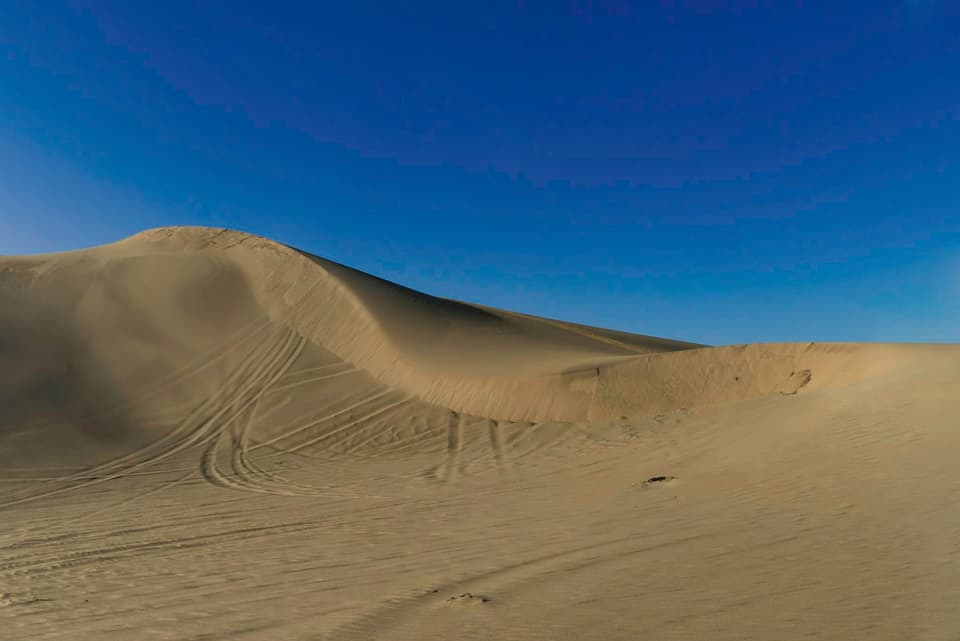 brown sand under blue sky
