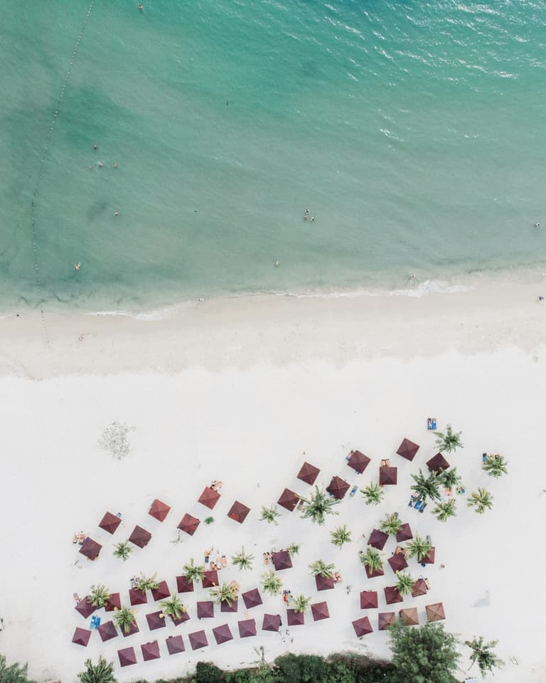 aerial photography of canopies on seashore during daytime