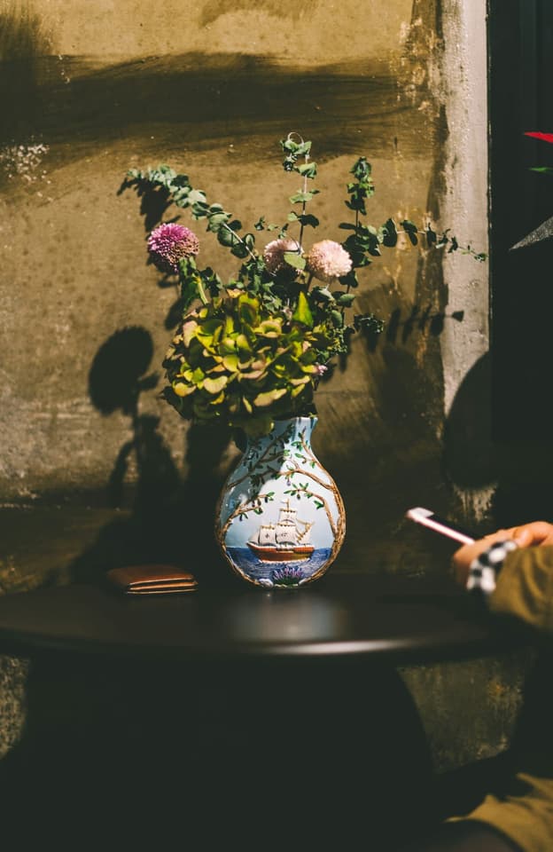 pink petaled flower on blue vase